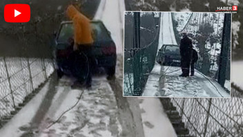 Metrelerce yükseklikteki asma köprüde korku dolu anlar! Buzda kayan otomobil asılı kaldı!