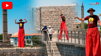 Tehlikeye dikkat çekmek için metrelerce yükseklikte 1,5 metrelik tahta bacaklarıyla yürüdü
