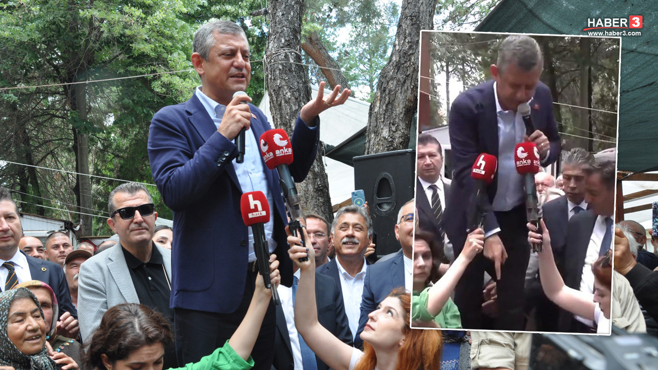 CHP Meclis Grup Başkanı Özgür Özel, Burdur'un Yeşilova ilçesinde bir bankın üzerinde halka sesleniyor.